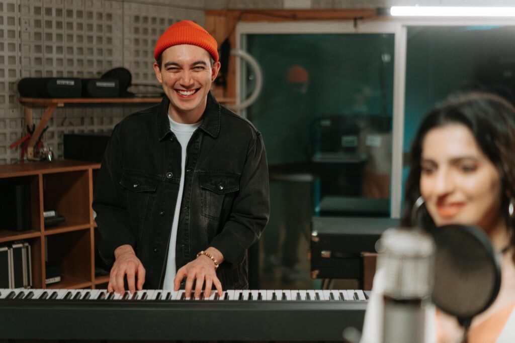 A joyful musician playing the keyboard in a music studio. Captures creativity and musical expression.