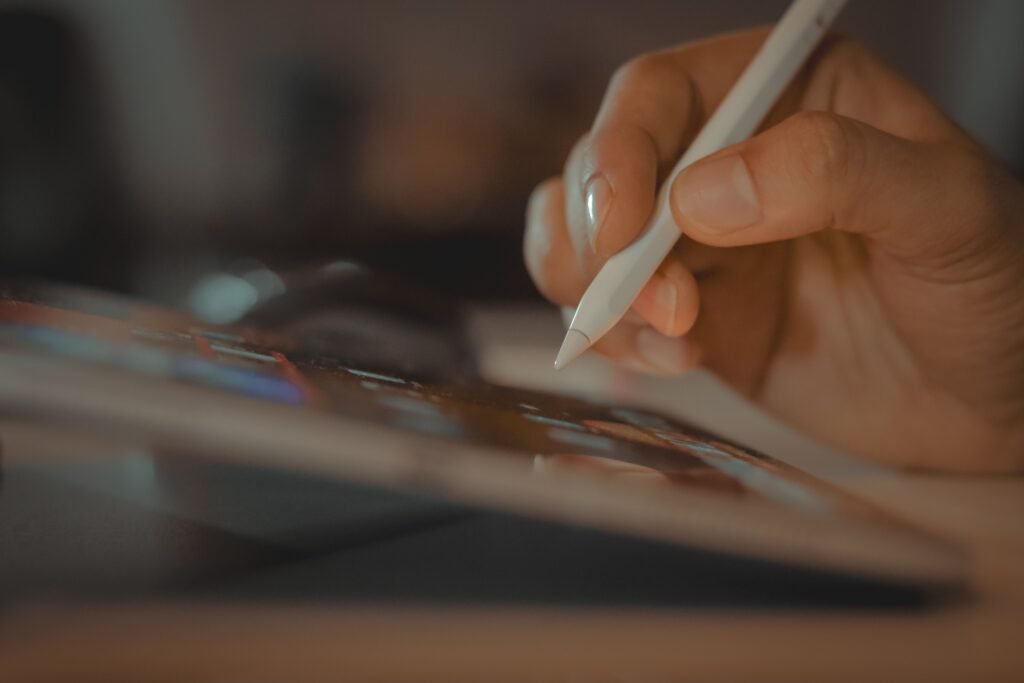 A close-up of a hand using a stylus on a tablet, showcasing digital interaction in Dubai.